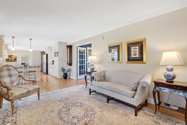 living room with light hardwood / wood-style floors and ornamental molding