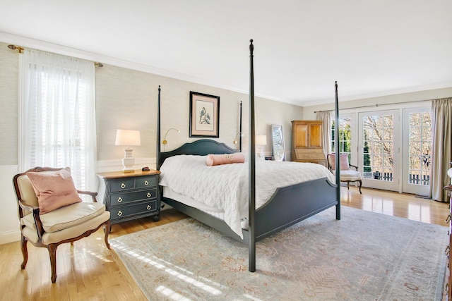 bedroom featuring wood-type flooring, crown molding, and access to outside