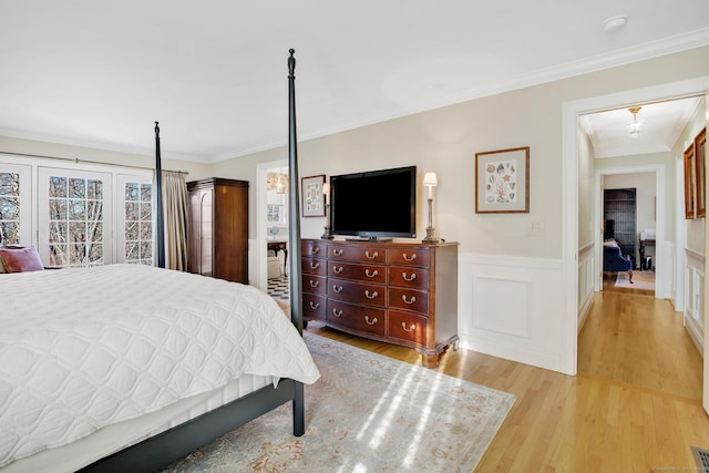 bedroom featuring ornamental molding and light wood-type flooring