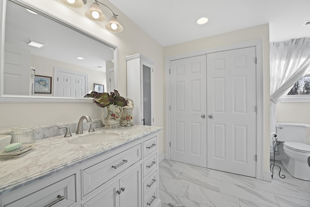 bathroom with vanity and toilet