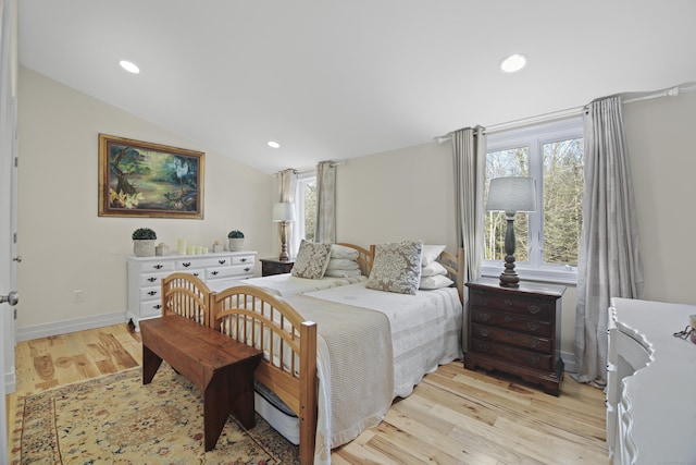 bedroom featuring light hardwood / wood-style floors and vaulted ceiling