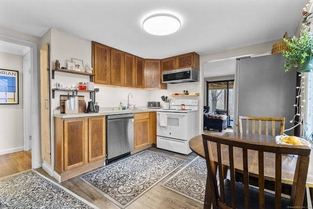 kitchen featuring sink, dark wood-type flooring, and appliances with stainless steel finishes