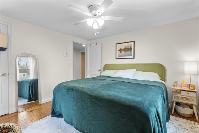 bedroom with light hardwood / wood-style flooring and ceiling fan