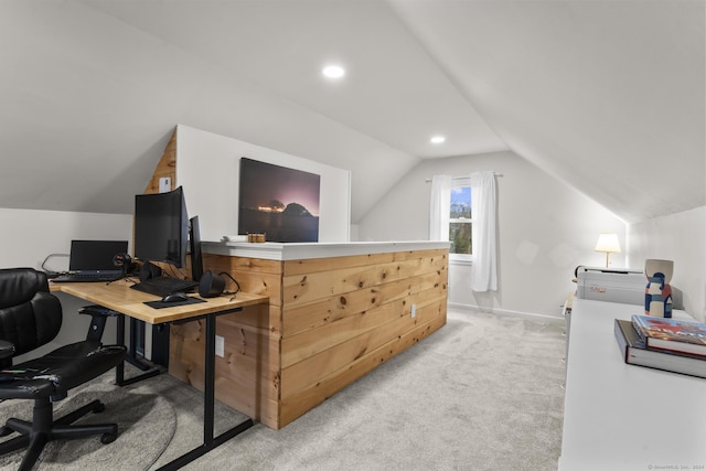 office area featuring light carpet and vaulted ceiling