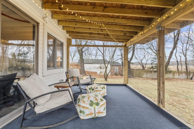 sunroom featuring beamed ceiling