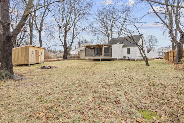 view of yard with a storage unit and a sunroom