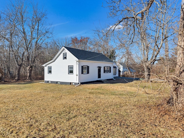 view of side of home featuring a lawn