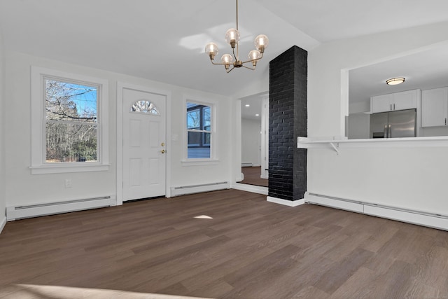 entryway with dark hardwood / wood-style flooring, lofted ceiling, a baseboard heating unit, and a notable chandelier