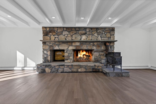 details with beamed ceiling, hardwood / wood-style flooring, baseboard heating, and a fireplace