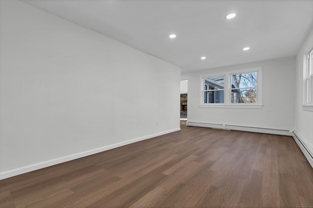 spare room featuring baseboards, dark wood-style flooring, recessed lighting, and baseboard heating