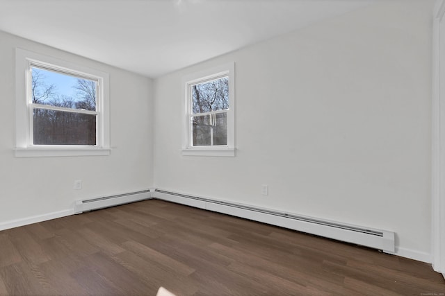 unfurnished room with dark wood-style floors, a baseboard radiator, and baseboards
