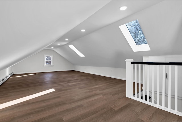 bonus room featuring lofted ceiling with skylight and dark wood-type flooring