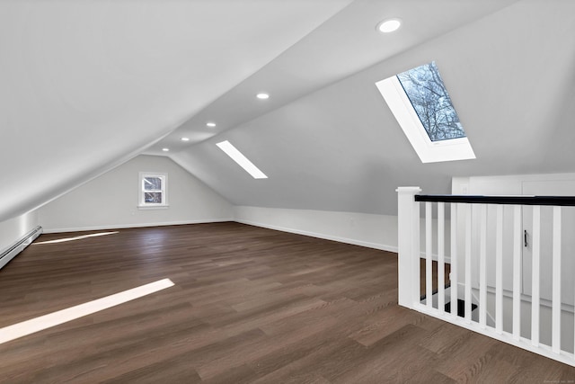 bonus room with recessed lighting, baseboards, vaulted ceiling with skylight, and wood finished floors