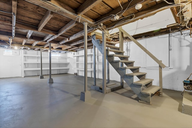 below grade area with concrete block wall and stairway