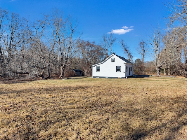 view of side of home featuring a yard