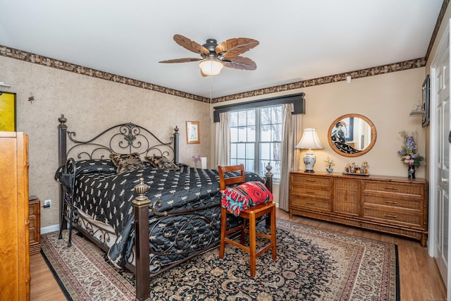 bedroom with light hardwood / wood-style flooring and ceiling fan