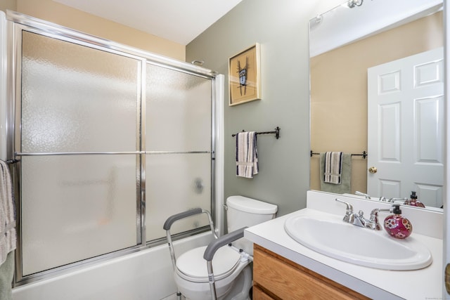 full bathroom with vanity, enclosed tub / shower combo, and toilet