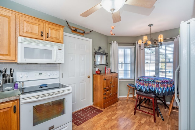 kitchen with backsplash, decorative light fixtures, white appliances, light brown cabinetry, and ceiling fan with notable chandelier