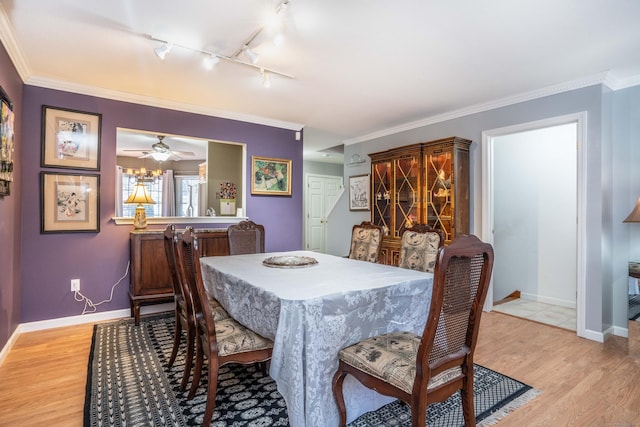 dining space featuring ceiling fan, ornamental molding, rail lighting, and light hardwood / wood-style flooring