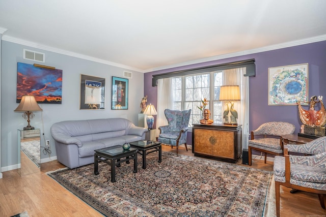 living room with light wood-type flooring and crown molding