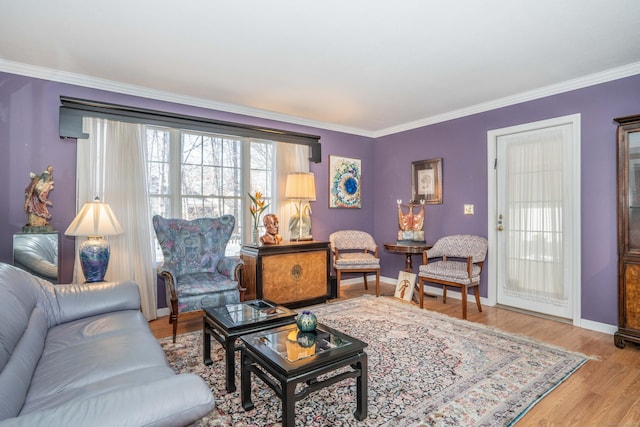 living room with light hardwood / wood-style floors and crown molding