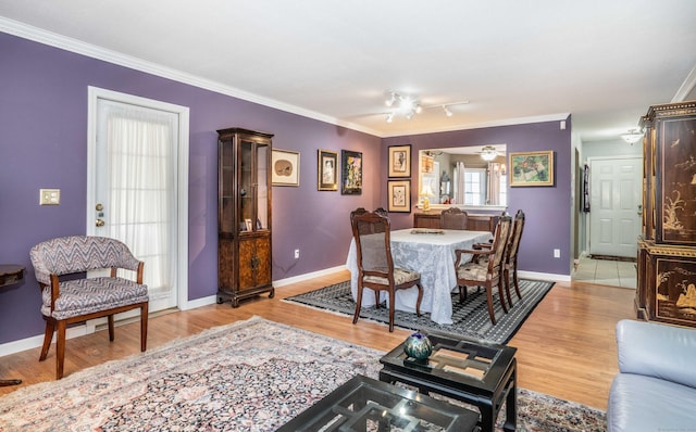 dining room featuring ceiling fan, ornamental molding, and light hardwood / wood-style flooring