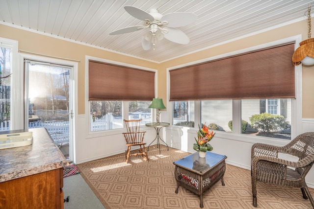 sunroom / solarium featuring ceiling fan and wood ceiling