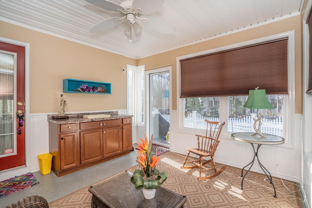 interior space featuring wooden ceiling, ceiling fan, and ornamental molding