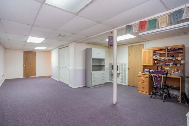 carpeted office with a paneled ceiling