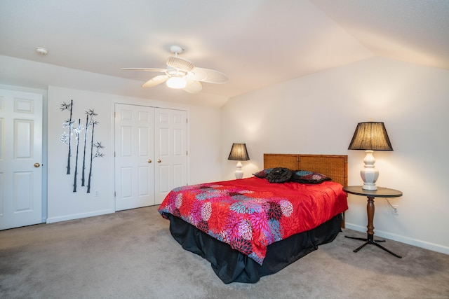 bedroom with ceiling fan, vaulted ceiling, light carpet, and a closet