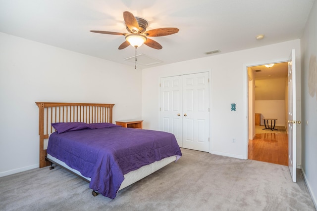 carpeted bedroom with ceiling fan and a closet