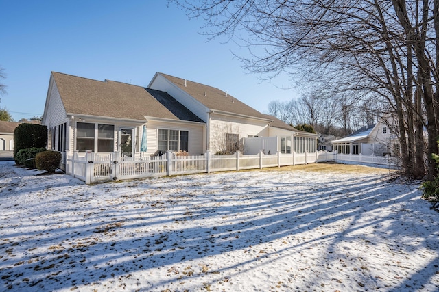 view of snow covered back of property