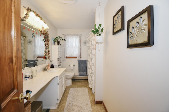 bathroom with tile patterned floors, vanity, and toilet