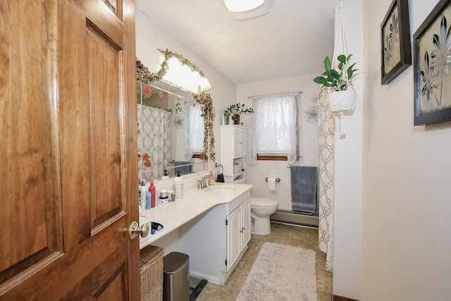 bathroom featuring vanity, toilet, and walk in shower