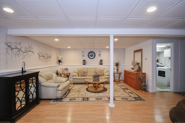 living room featuring wood-type flooring and washer / clothes dryer