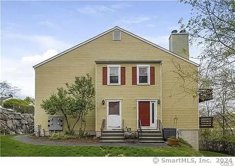 view of front facade with central AC and a front lawn