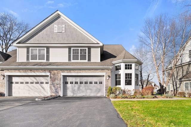 view of front property with a front yard and a garage