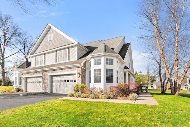 view of side of property featuring a lawn and a garage