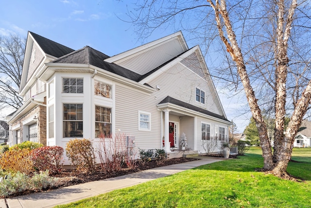 view of front of property with a garage and a front yard