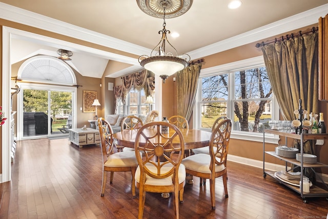 dining room featuring crown molding, dark hardwood / wood-style flooring, and lofted ceiling