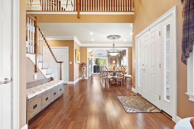 entryway featuring dark hardwood / wood-style floors and crown molding