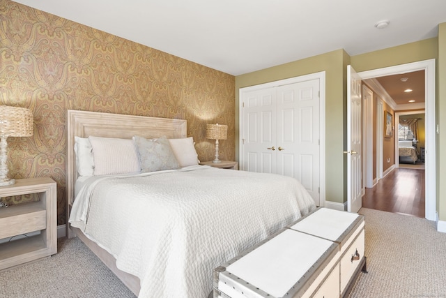 bedroom featuring light colored carpet and a closet