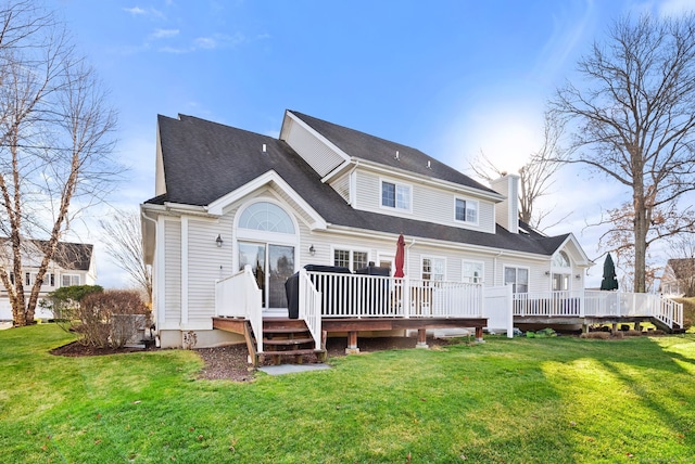 back of house featuring a lawn and a deck