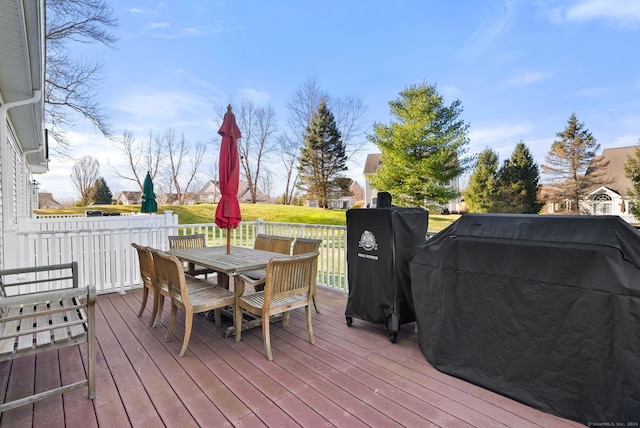 wooden deck featuring grilling area and a yard