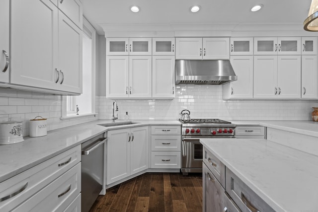 kitchen featuring wall chimney exhaust hood, appliances with stainless steel finishes, glass insert cabinets, and white cabinets