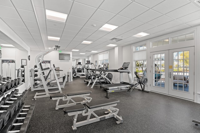 gym with french doors, a drop ceiling, and visible vents