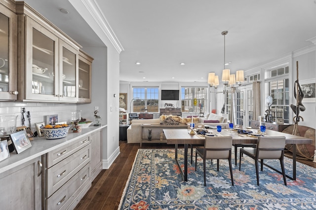 dining area featuring dark wood-type flooring, recessed lighting, and crown molding