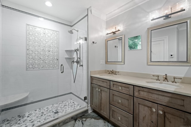 full bathroom with crown molding, double vanity, a sink, and a shower stall