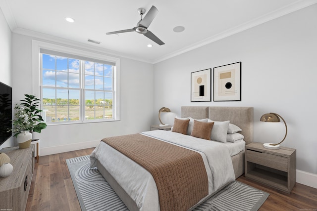 bedroom featuring dark wood finished floors, visible vents, ornamental molding, ceiling fan, and baseboards