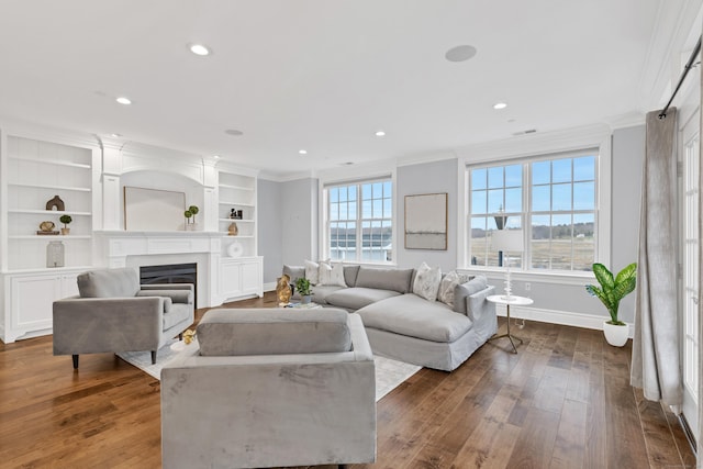 living area featuring dark wood-style flooring, baseboards, and ornamental molding